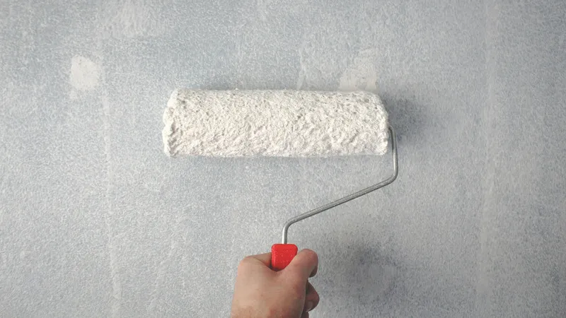 Paint roller in use, representing tools and supplies tied to home improvement return policies.